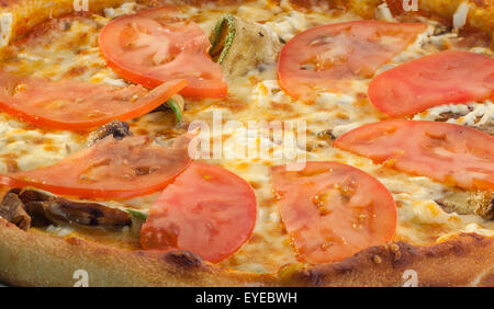 delicious vegetarian pizza with tomatoes and zucchini Stock Photo