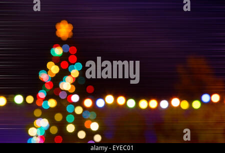 Christmas tree with unfocused tree in the night,composite image Stock Photo