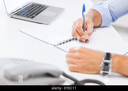 businessman writing in notebook Stock Photo