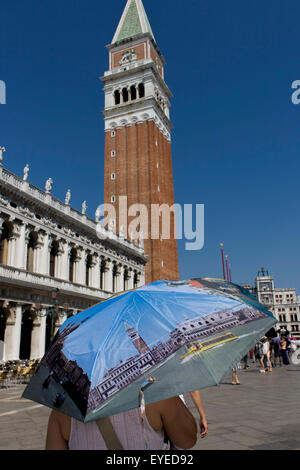 Tourist umbrella beneath the Campanile in Piazza San Marco Stock Photo