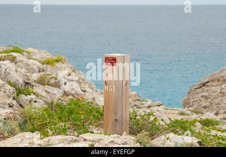 A wooden marker post on the Cami de Cavalls bridal path on the island of Menorca Spain Stock Photo