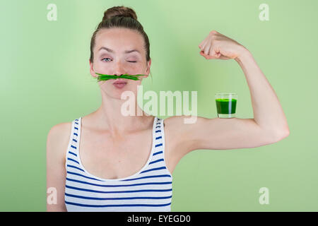 Fit and strong with wheat grass juice Stock Photo