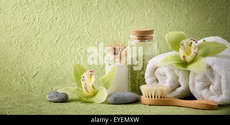 Spa still life with salt,towel,brush and blooming orchid Stock Photo