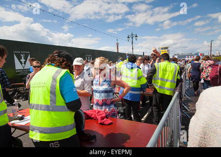 Security staff examing bags at entrance to event Stock Photo