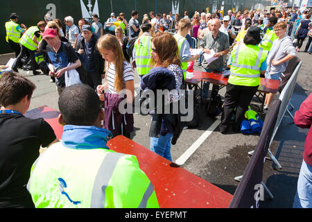 Security staff examing bags at entrance to event Stock Photo