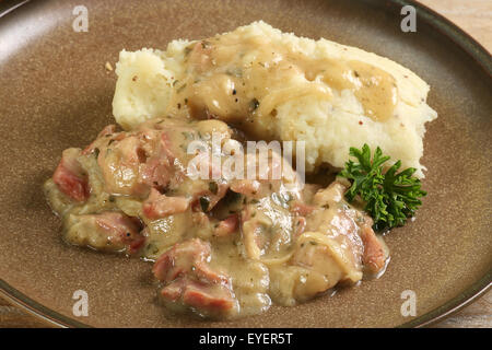 shredded ham hock in cider sauce wit mustard mash Stock Photo