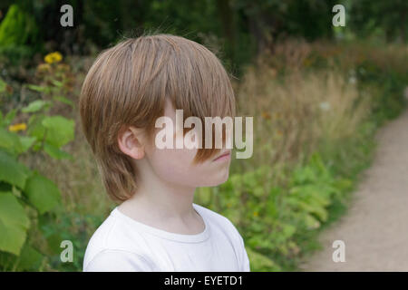 portrait of a young boy with his hair covering his eyes Stock Photo