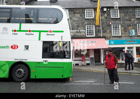 Dolgellau, Gwynedd, Wales double decker bus and walker in Eldon Square in the centre of Dolgellau in July Stock Photo