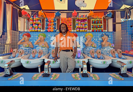 A young man at his summer job running the Stinky Feet concession at Coney Island, Brooklyn, New YorCity Stock Photo