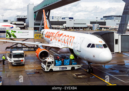 Easyjet plane being loaded with luggage at Gatwick airport, London, England, UK