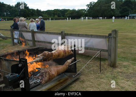 Lamb roast. Village Cricket roasting two split lambs sheep on a BBQ. lunch for the Ebernoe village cricket club at annual Horn Fair cricket match on the Common. Ebernoe  Sussex UK England. 2015 2010s HOMER SYKES Stock Photo