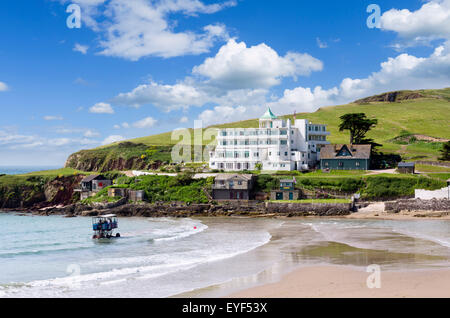 Burgh Island Hotel with sea tractor used to cross at high tide in foreground, Burgh Island, Bigbury-on-Sea, Devon, England, UK. Example of a tombolo. Stock Photo