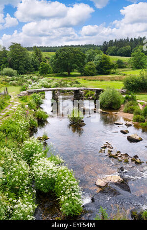 The historic clapper bridge over the East Dart River in Postbridge, Dartmoor, Devon, England, UK Stock Photo