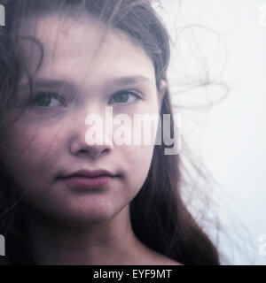 headshot of a young and sad teenage girl
