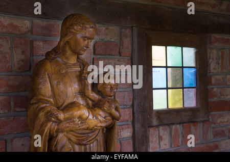 wooden statue of virgin mary with jesus child in her arms Stock Photo