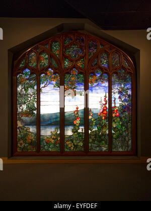 A 1905 stained glass window by Louis Comfort Tiffany for client Melchior Beltzhoover depicts the Hudson River in Art Nouveau style. Note hollyhock motif. Stock Photo