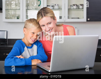 Mother and son (8-9) using laptop Stock Photo