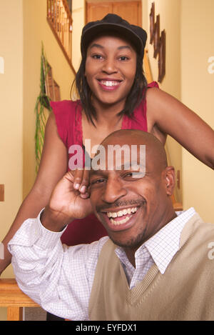 An African American middle class couple poses in their living room in Corona, CA. Stock Photo