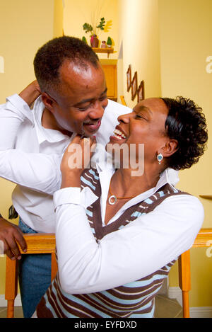 An African American middle class couple poses in their living room in Corona, CA. Stock Photo