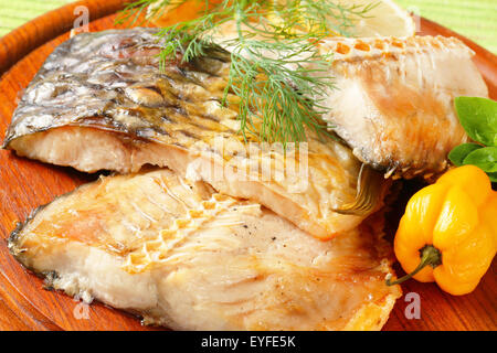 Oven baked carp fillets with dill Stock Photo