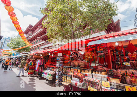 Outside stalls in Singapore's Chinatown district selling tourist souvenirs, purses, scarves and much more. Stock Photo