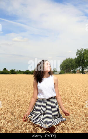 Young girl have fun in the wheat field Stock Photo