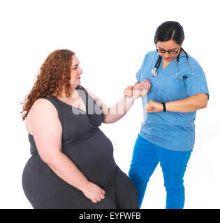 Nurse in scrubs with patient taking pulse Stock Photo