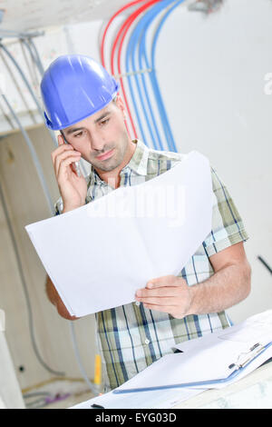 Building consulting plans on telephone Stock Photo
