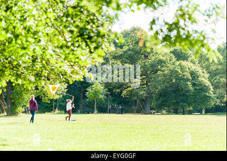 Girls fly a kite in the park Stock Photo