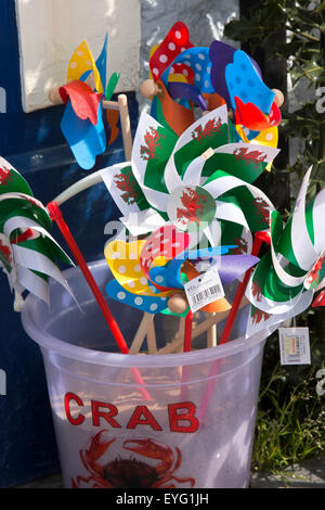 UK, Wales, Gwynedd, Aberdovey, seafront beach supplies shop selling welsh flag children’s windmills in crabbing bucket Stock Photo