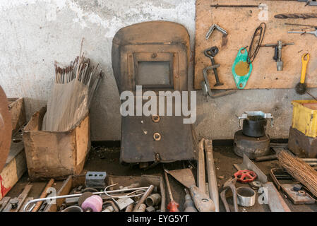 old workbench with old work tools in home garage Stock Photo