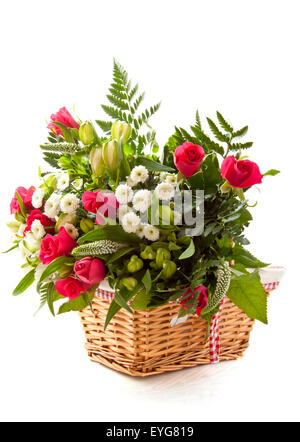 Colorful bouquet in wooden basket over white Stock Photo