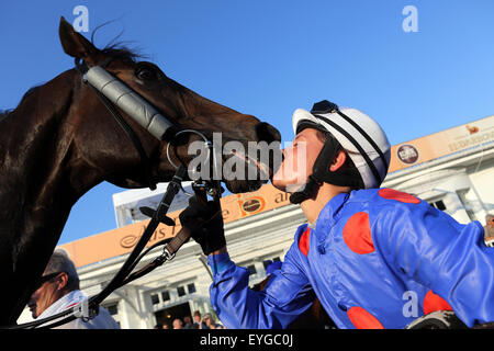 Hamburg, Germany, racing rider kisses her horse after winning Stock Photo