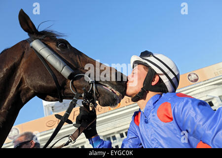 Hamburg, Germany, racing rider kisses her horse after winning Stock Photo