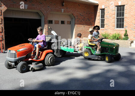 Du Bois, United States, boys ride on lawn tractors Stock Photo