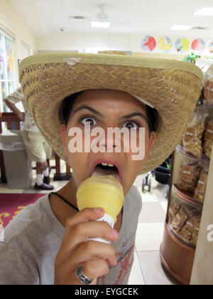 Saint Petersburg, Florida, girl with hat eating an ice cream Stock Photo