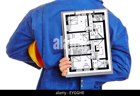 Worker holding floor plan of house on a clipboard behind his back Stock Photo