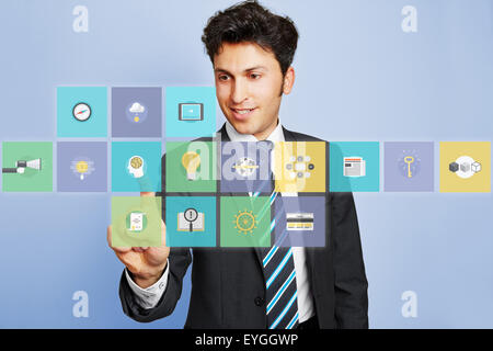 Business man pushing virtual brain icon button on a touchscreen Stock Photo