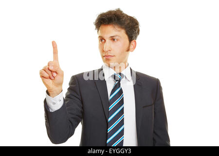 Business man pressing his index finger on a touchscreen Stock Photo