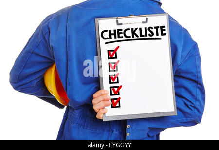 Construction worker holding clipboard with German word "Checkliste" (checklist) behind his back Stock Photo