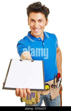 Smiling craftsman holding an empty white clipboard in his hand Stock Photo