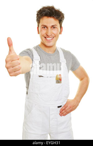 Happy painter in white overall holding thumbs up Stock Photo