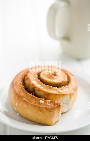 cinnamon bun on white plate Stock Photo