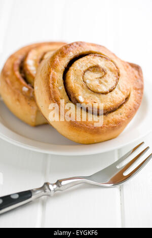 cinnamon buns on white plate Stock Photo
