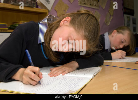 Secondary school pupils studying and writing in class, Surrey, UK. Stock Photo