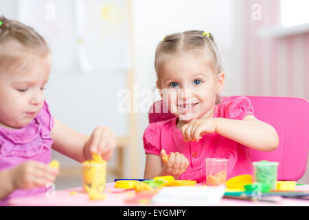 children playing with colorful clay Stock Photo