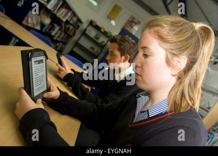 Secondary school pupils using Kindles in school library, Surrey, UK. Stock Photo