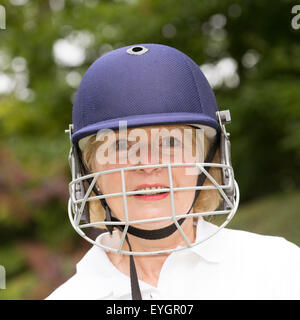 Portrait of an elderly woman cricketer wearing a batswoman's safety helmet Stock Photo