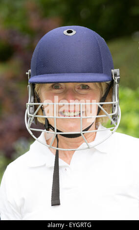 Portrait of an elderly woman cricketer wearing a batswoman's safety helmet Stock Photo