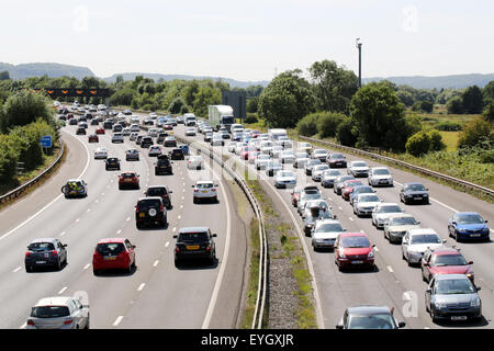 Queues of heavy traffic, in both directions, on the motorway during a busy summer weekend. Stock Photo